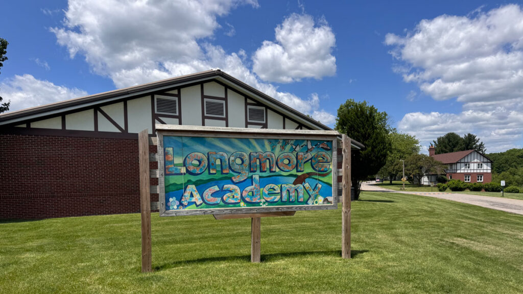 Color sign in front of Longmore Academy